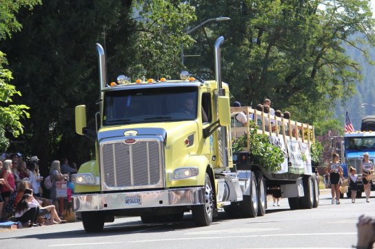 Image of a yellow big rig with a crowd watching